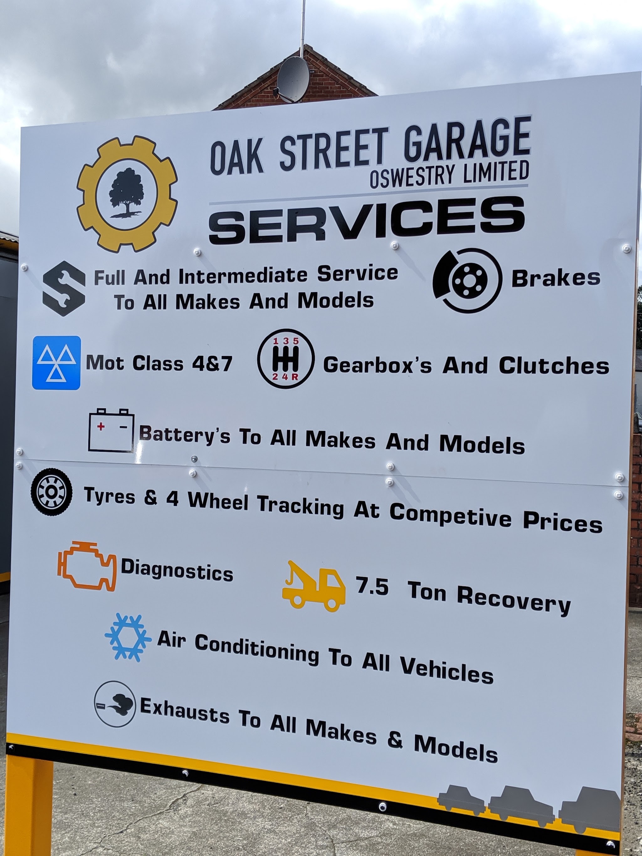 The Oak Street Garage services sign listing services, brakes, MOT Class 4 and 7, gearboxes and clutches, batteries, tyres and tracking, diagnostics, 7.5 ton recovery, air conditioning and exhausts